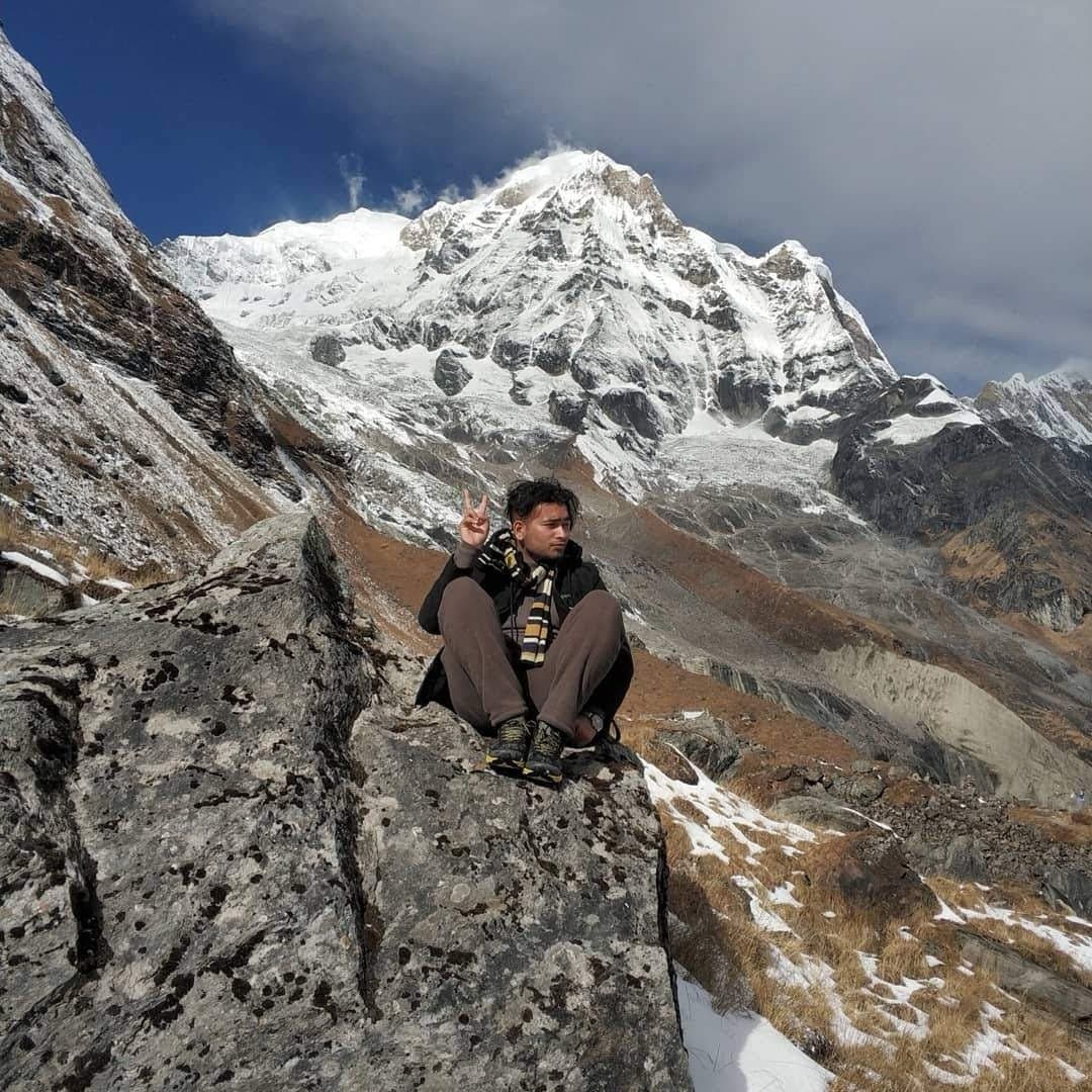 Sitting below snowy mountain peaks