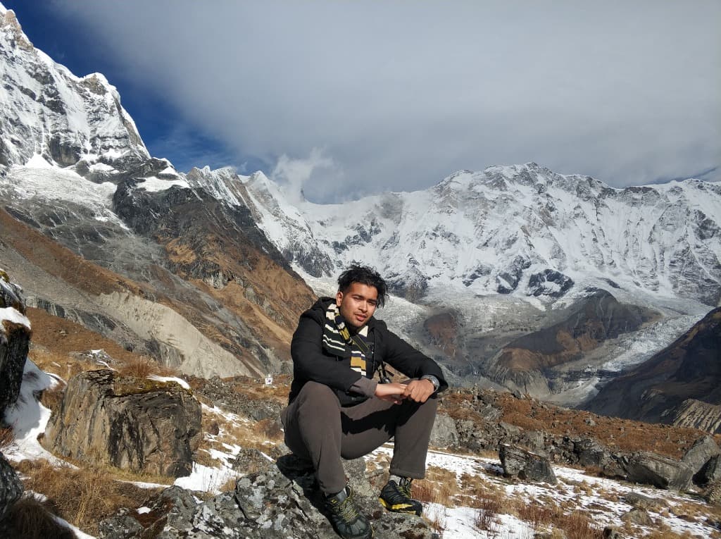 Sitting in front of snowy mountains