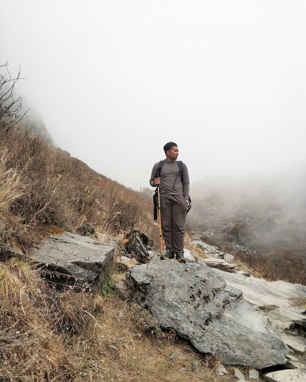 Standing on a foggy mountain trail